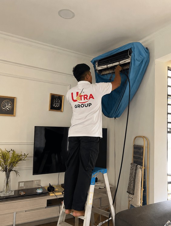 Aircon Care technician chemical-washing a wall-mounted air conditioner
